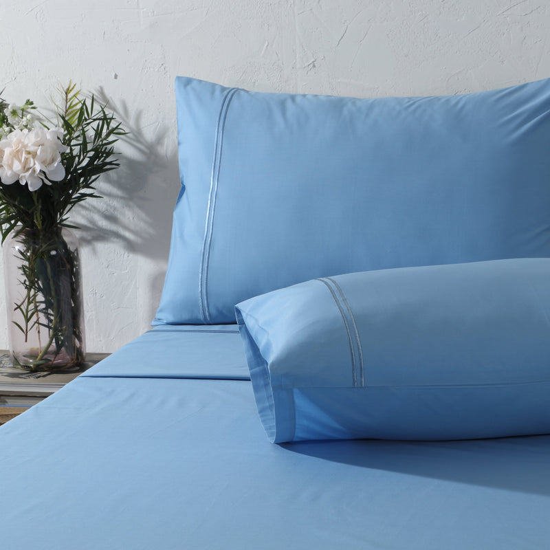 Whites of London Coloured Organic Cotton Sheet Sets Blue Mirage 250TC – embroidered pillowcases angled bedroom lifestyle NZ
