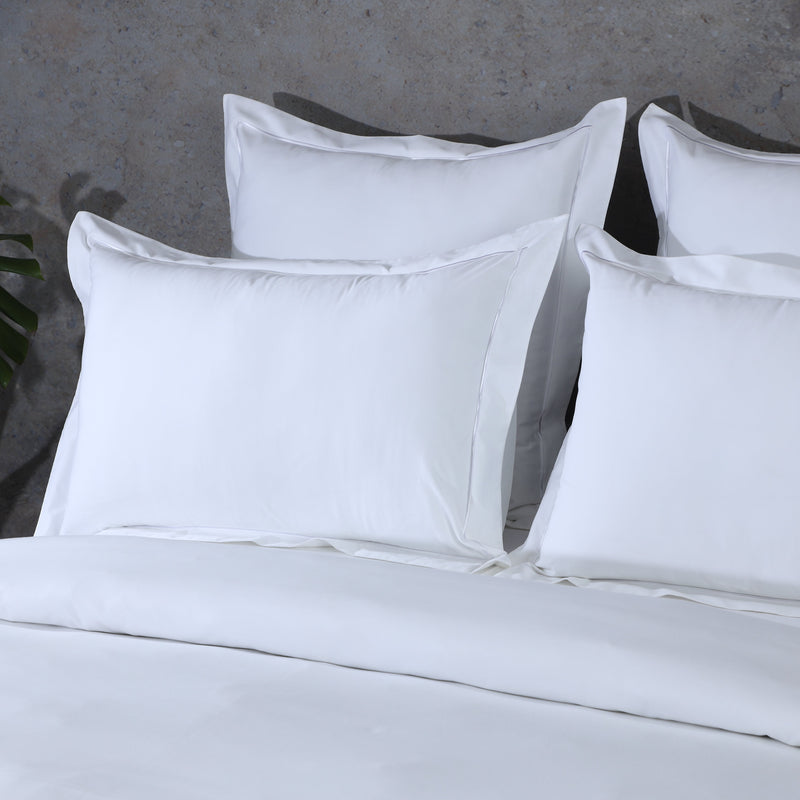 White Organic Cotton Embroidered Pillowcases styled on bed, displaying both oxford style as well as Euro in white, 750 thread count. Whites of London , free shipping New Zealand and Australia 