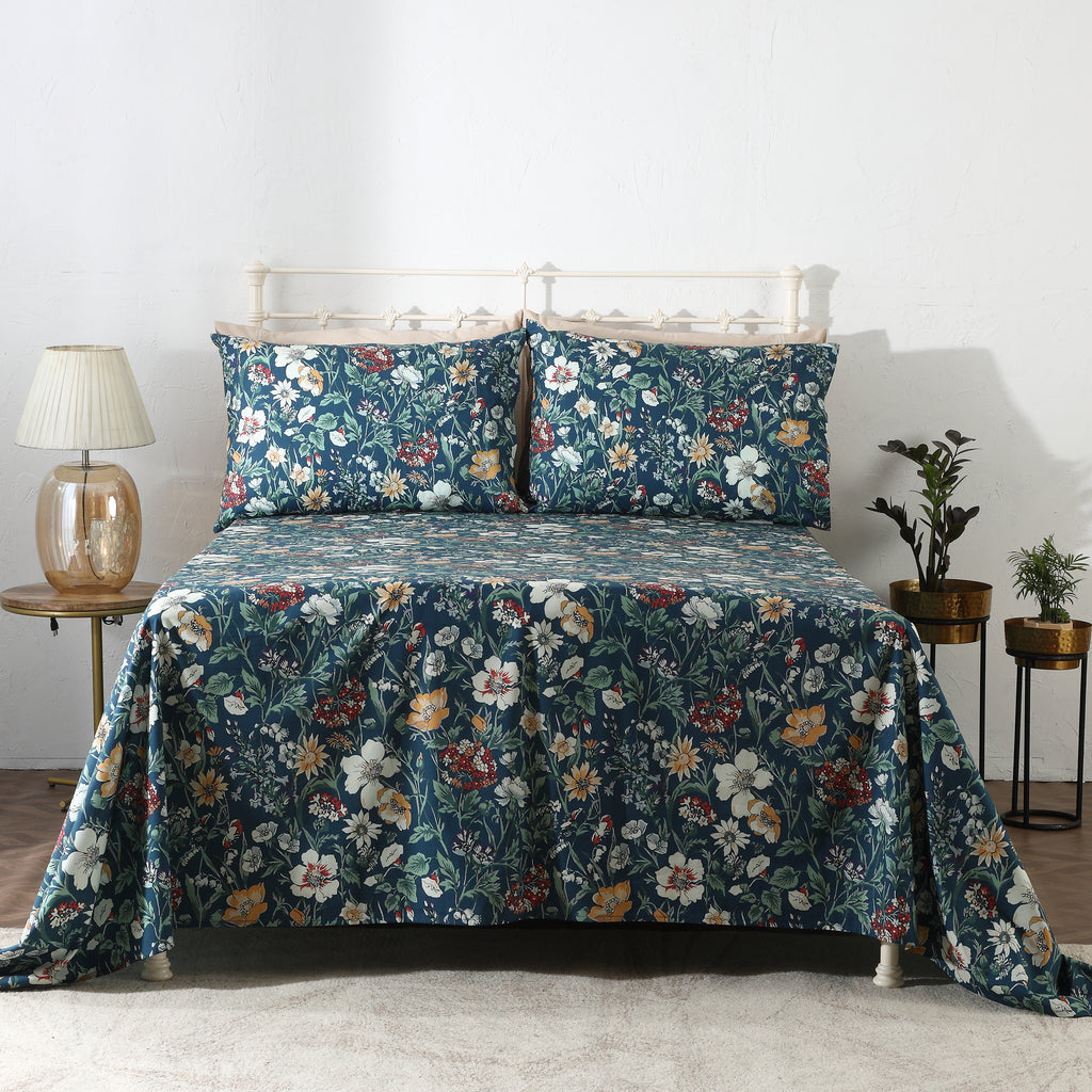 Front view of Adriana Blue 250TC GOTS certified organic cotton percale printed sheet set on bed, soft blue floral design with layered blooms