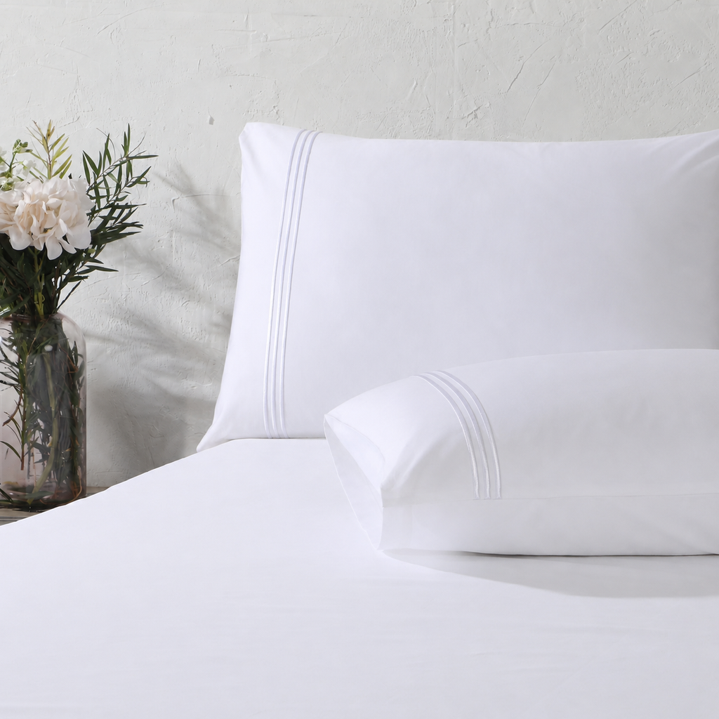 Close up of pillowcase with triple cord embroidery: 1250TC GOTS certified Organic Cotton Sheet Set white pillowcase flat sheet detail and Organic Cotton Fitted Sheet Whites of London 