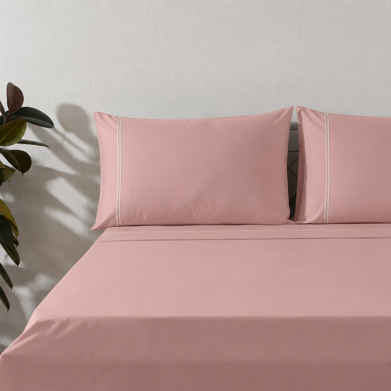 Dusty Pink GOTS certified organic cotton 250TC styled on bed with matching pillowcases