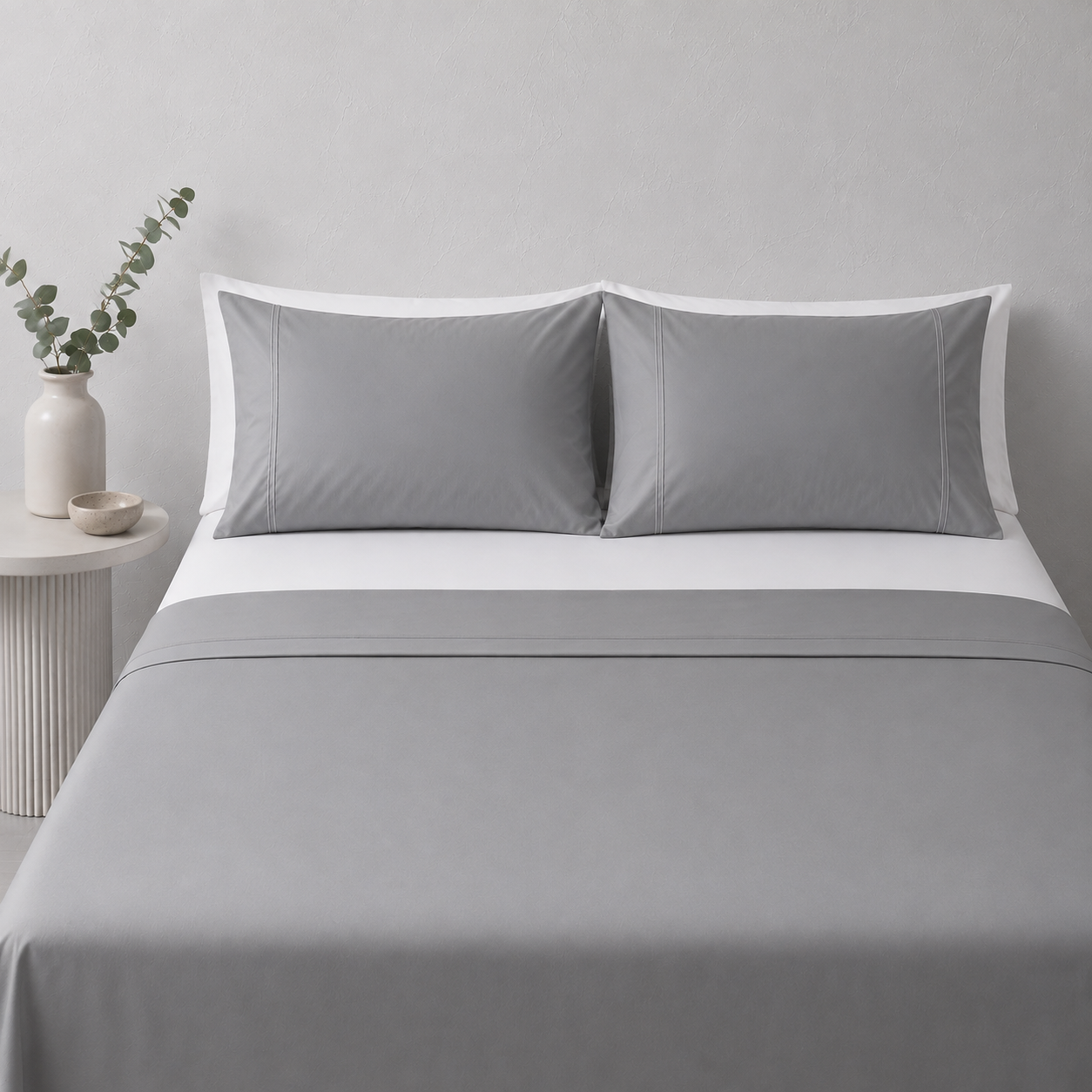 Greystone 250TC certified organic cotton sheet set styled with fitted sheet and white pillowcases