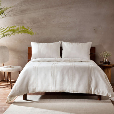 Full bed front on ivory pure linen duvet cover wooden headboard concrete wall palm: Heirloom 100% European French flax linen in ivory duvet cover set wooden headboard concrete wall NZ Whites of London