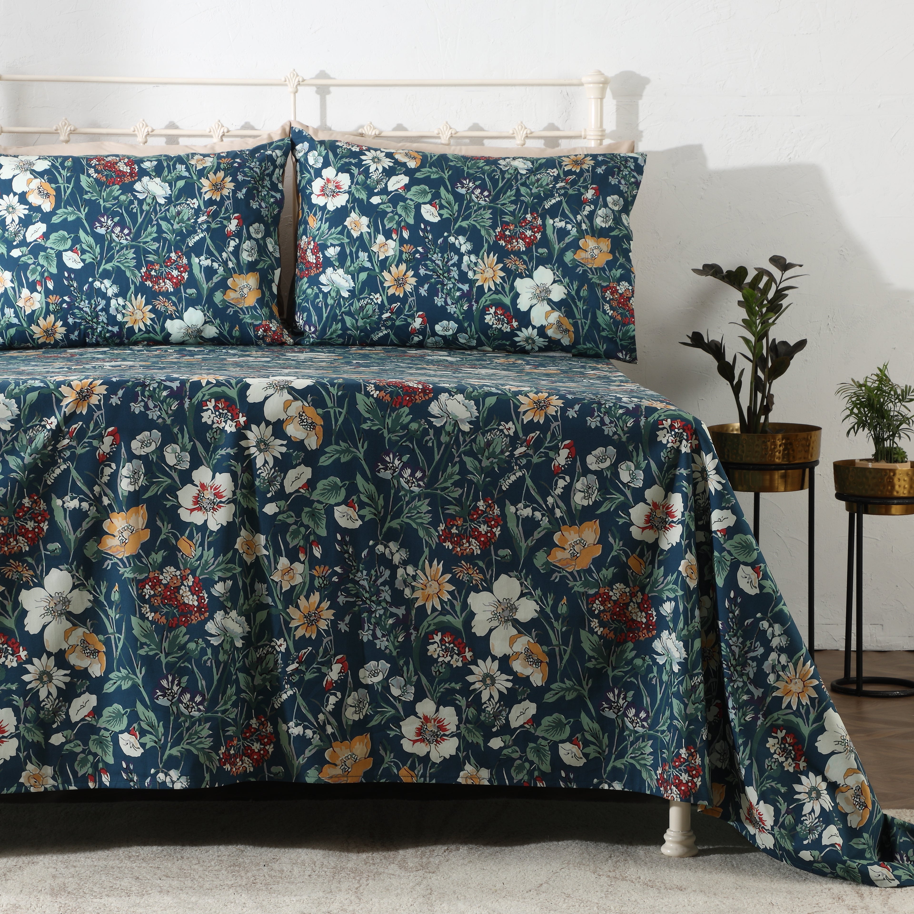 Right side view of Adriana Blue 250TC GOTS certified organic cotton percale printed sheet set on bed, showing layered floral pattern in blue and sage