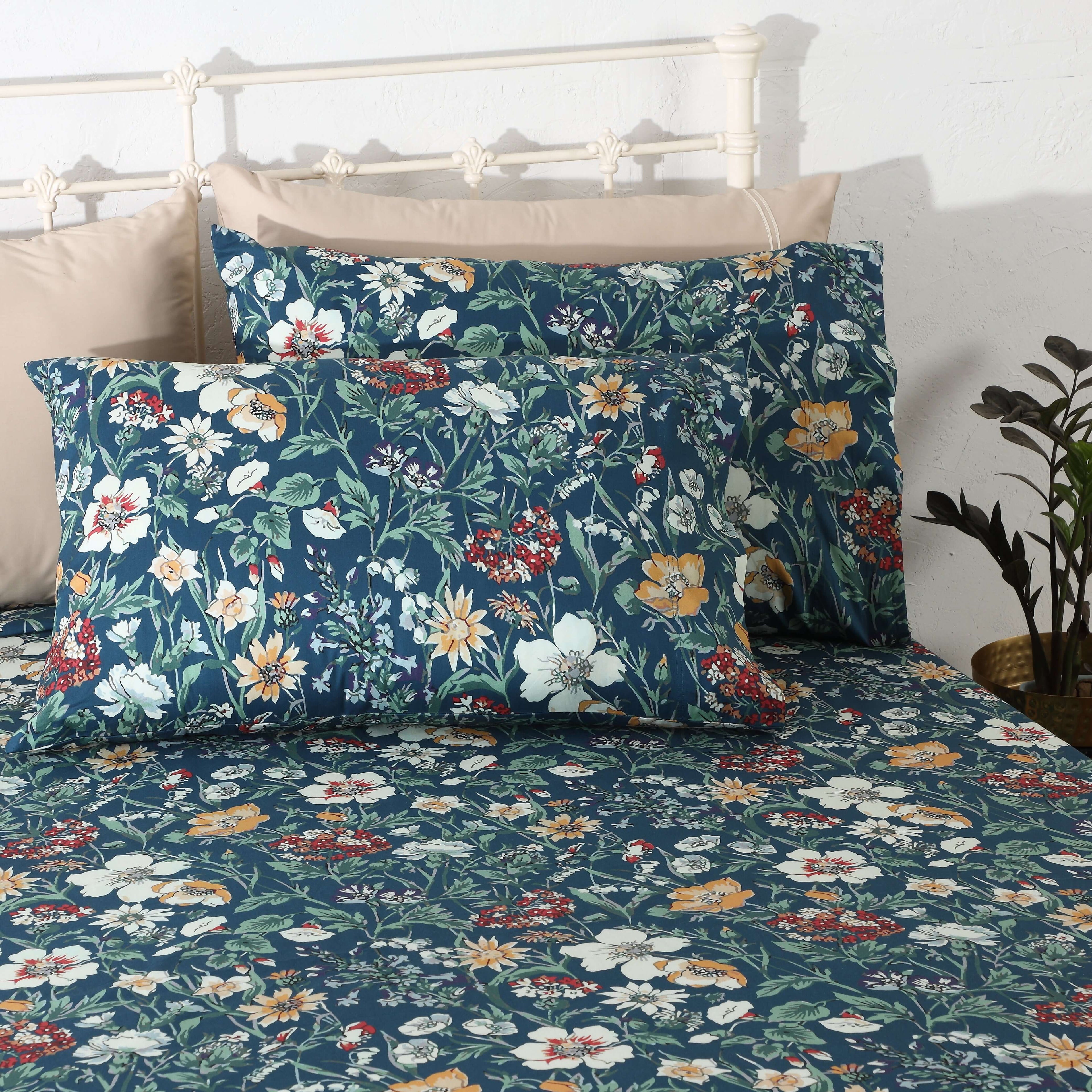 Front view of Adriana Blue 250TC GOTS certified organic cotton percale printed sheet set with matching pillowcases displayed on bed, soft blue floral design