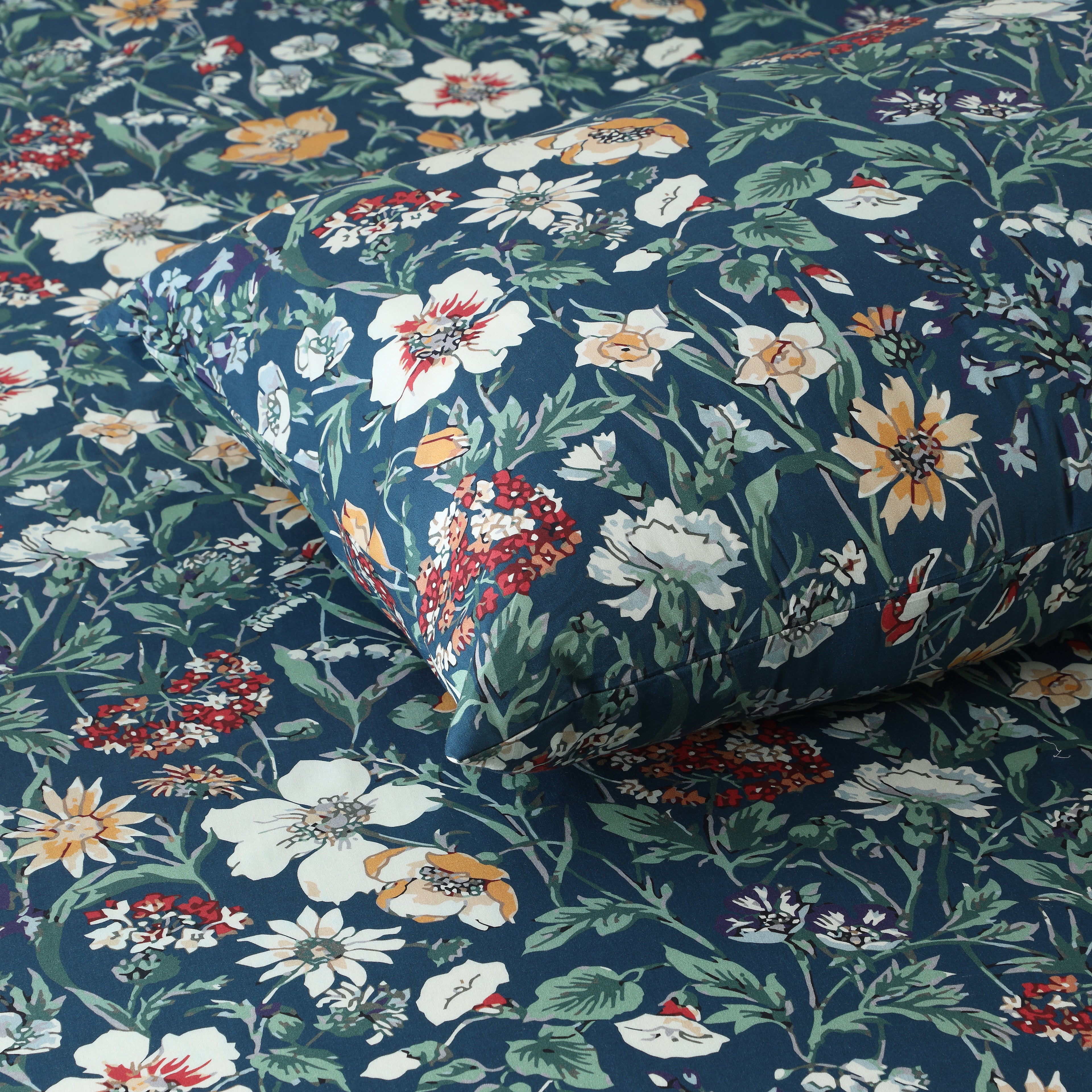 Close-up of Adriana Blue 250TC GOTS certified organic cotton percale printed sheet set pillowcase showing detailed soft blue floral print