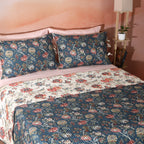 Percale Reversible Quilt Set showing reverse side in Chintz Percale on styled bed teal and cream jacobean floral Whites of London