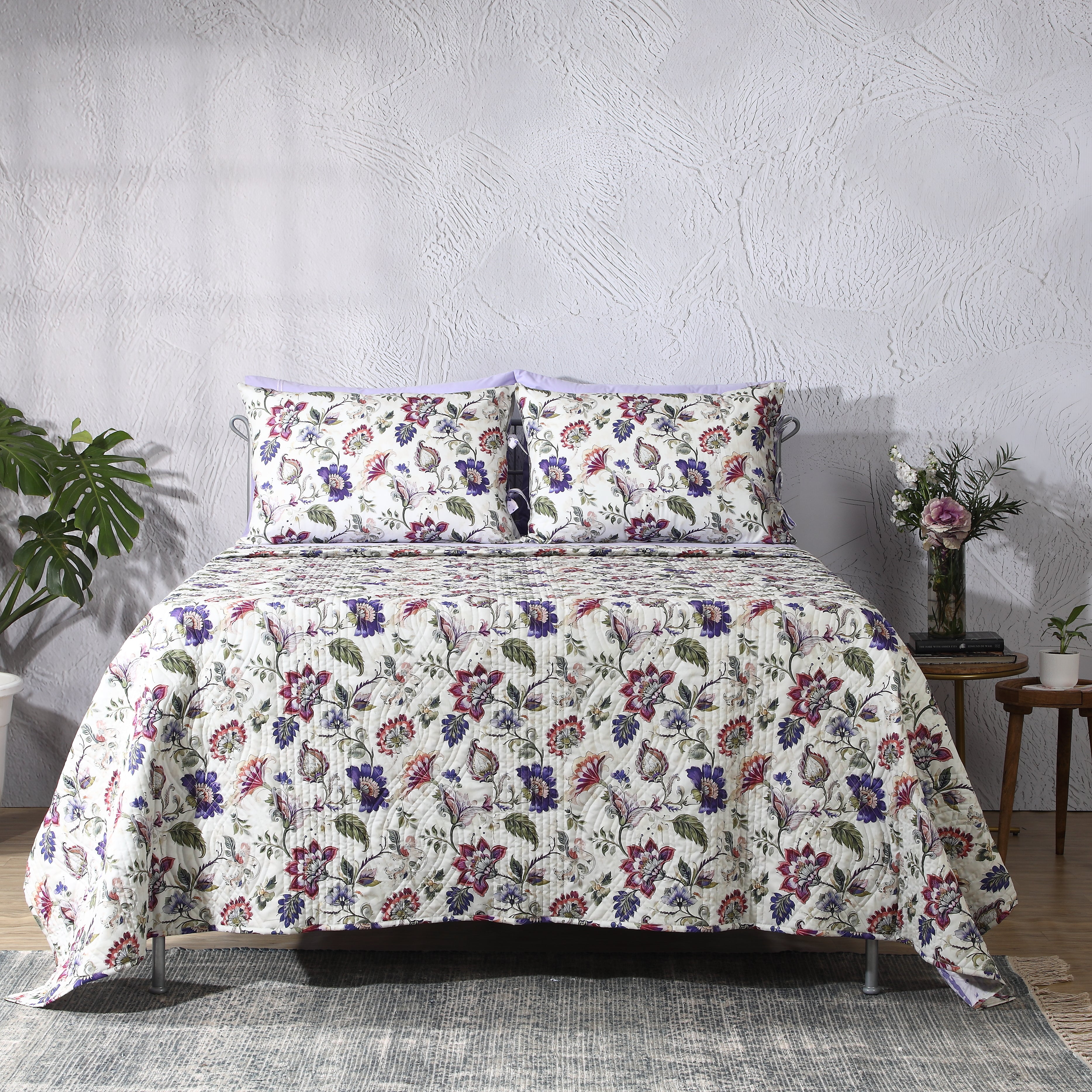 Front view of Lavender Fields percale reversible quilt set with matching pillowcases on bed, soft lavender floral design