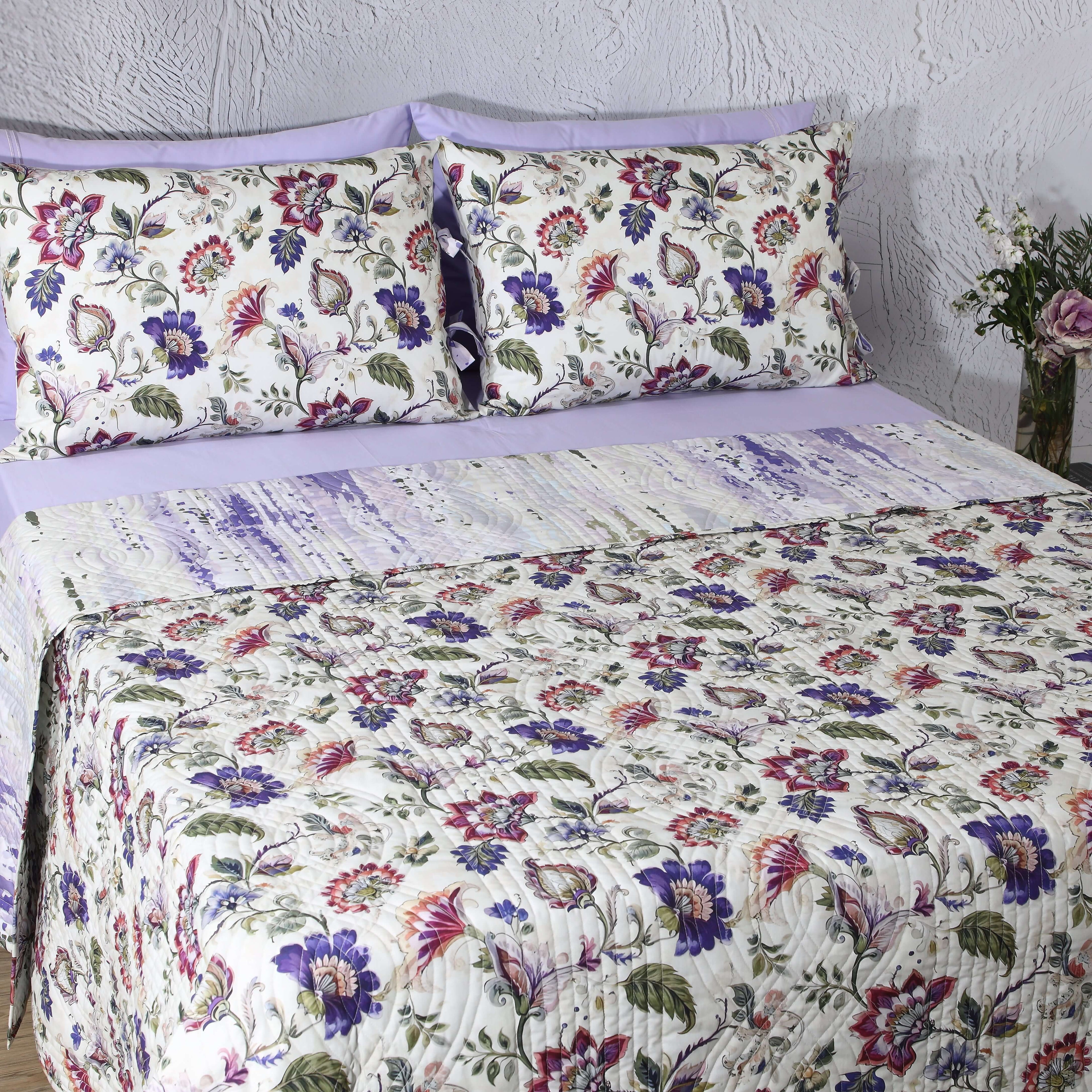 Wide bedroom view featuring Lavender Fields percale reversible quilt set on bed with matching pillowcases and styled décor
