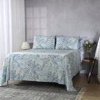 Wide bedroom lifestyle shot with full sheet set visible: Windflower GOTS certified organic cotton percale printed sheet set blue floral printed sheet set bedroom lifestyle Whites of London NZ