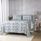 Styled bedroom view featuring Flint 250TC GOTS certified organic cotton percale printed sheet set on bed, geometric blue, slate, and grey print
