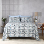 Front view of Flint 250TC GOTS certified organic cotton percale printed sheet set on bed in blue, slate, and grey