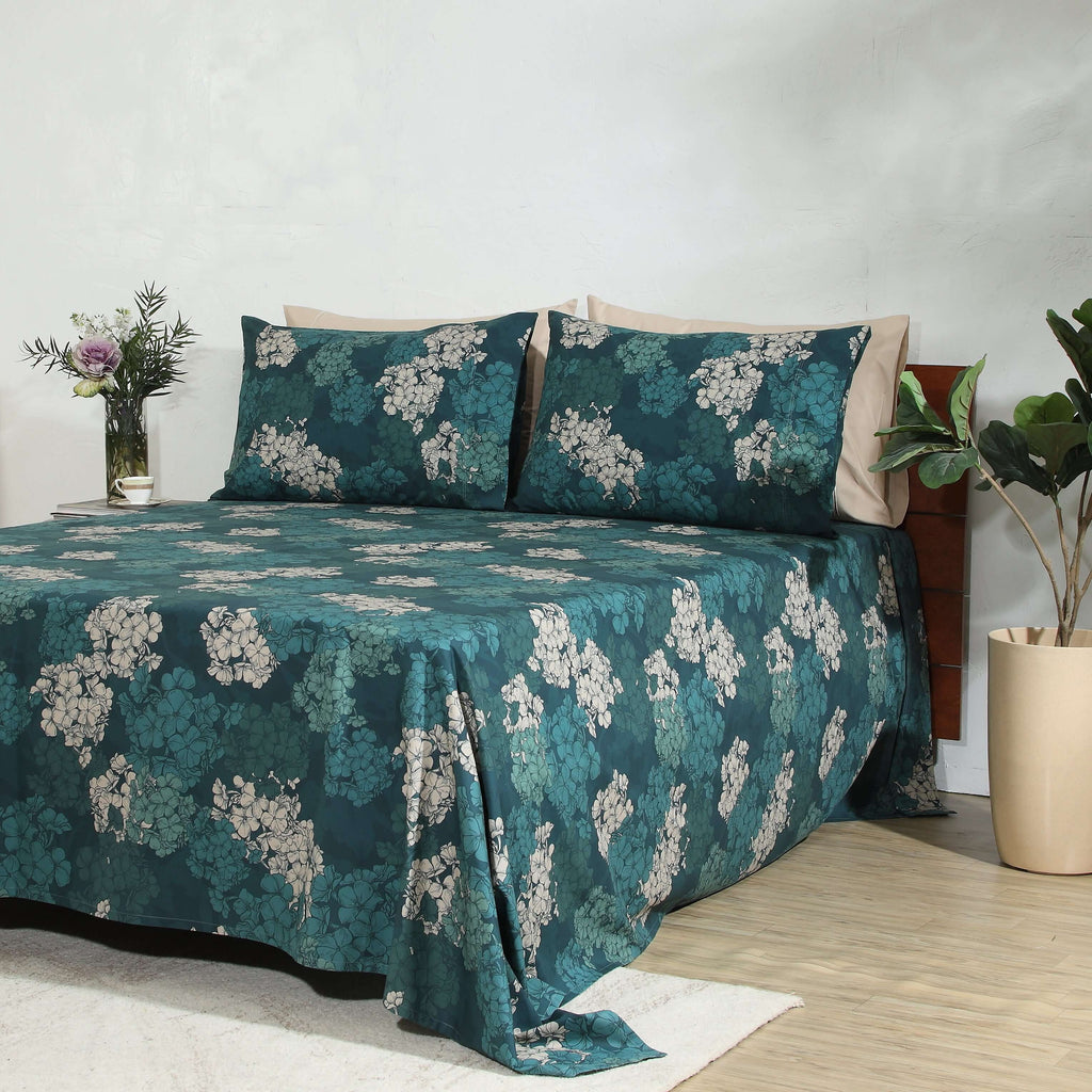 Full bed side angle lifestyle shot: Hydrangea GOTS certified organic cotton percale printed sheet set percale printed sheet set deep teal botanical floral Whites of London