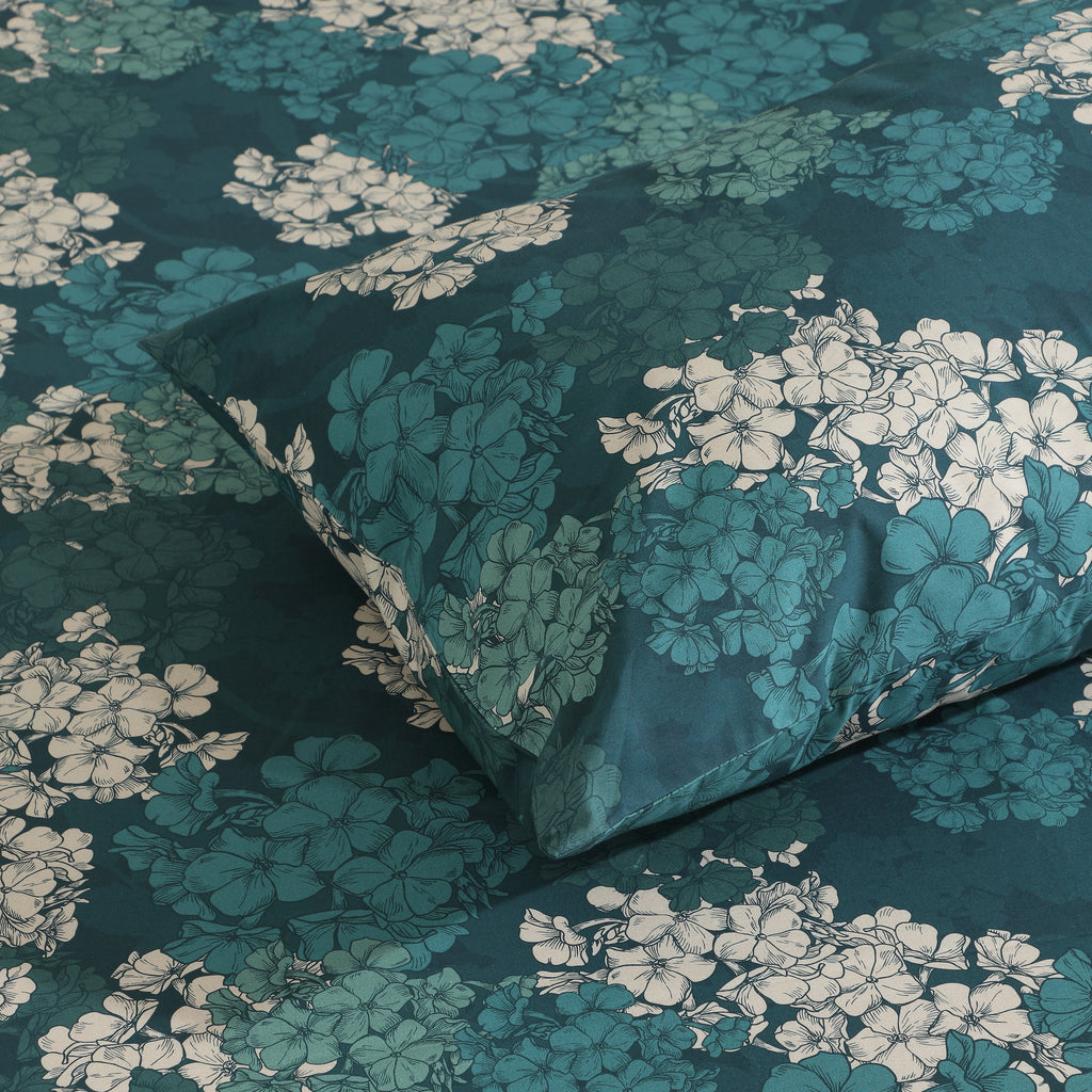 Detail of Hydrangea teal floral design on pillowcase, 250TC GOTS certified organic cotton percale printed sheet set close-up