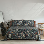 Front view of Adriana Black 250TC GOTS certified organic cotton percale printed sheet set displayed on a bed, black floral design with ivory, ochre, sage, and crimson accents