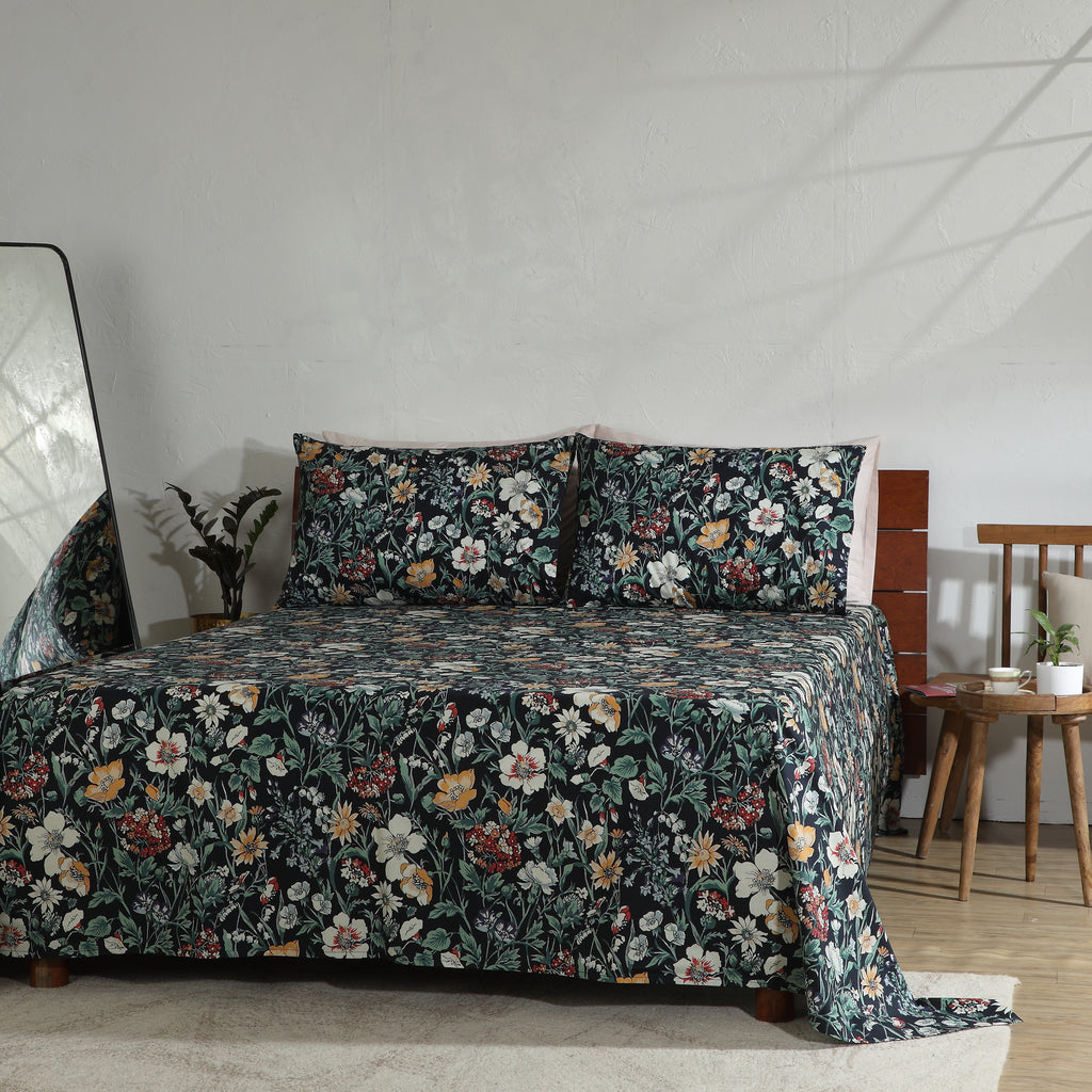 Wide view of bedroom featuring Adriana Black 250TC GOTS certified organic cotton percale printed sheet set on bed, black floral print with coordinating pillows and styled décor