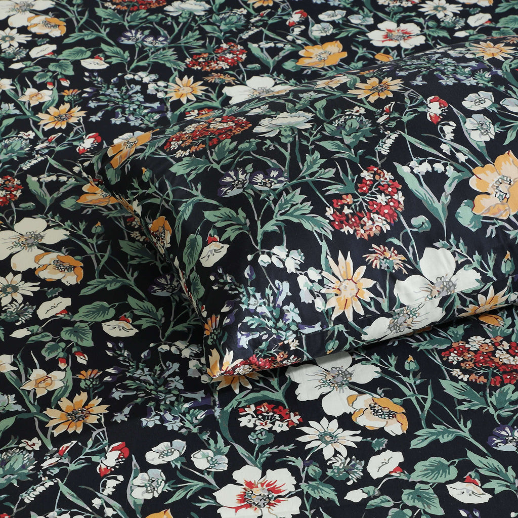 Close-up of Adriana Black 250TC GOTS certified organic cotton percale printed sheet set showing detailed black botanical floral design and fine painterly line work