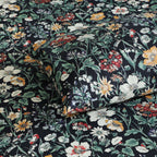 Close-up of Adriana Black 250TC GOTS certified organic cotton percale printed sheet set showing detailed black botanical floral design and fine painterly line work