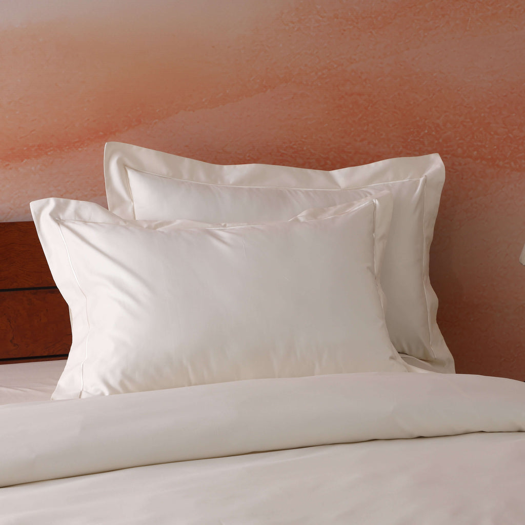 Styled luxury bedroom with ivory 750TC GOTS certified organic cotton pillowcases on bed