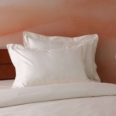Styled luxury bedroom with ivory 750TC GOTS certified organic cotton pillowcases on bed