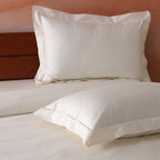 Close-up of embroidery detail on ivory 750TC GOTS certified organic cotton pillowcase