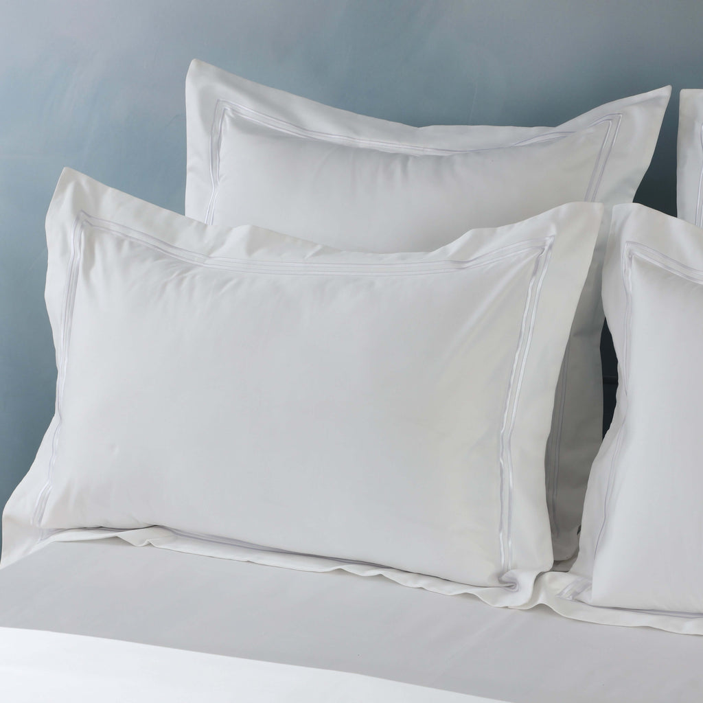 White euro GOTS certified organic cotton pillowcase stacked on bed showing embroidered with Oxford style, 1250TC euro pillowcases