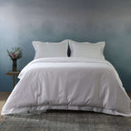 Lifestyle bedroom shot with white 1250TC organic cotton pillowcases and matching duvet cover, oxford style
