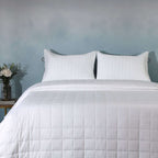 Clean front on full bed shot with teal wall background: White bamboo cotton bedspread set quilted square design full bed teal wall Whites of London