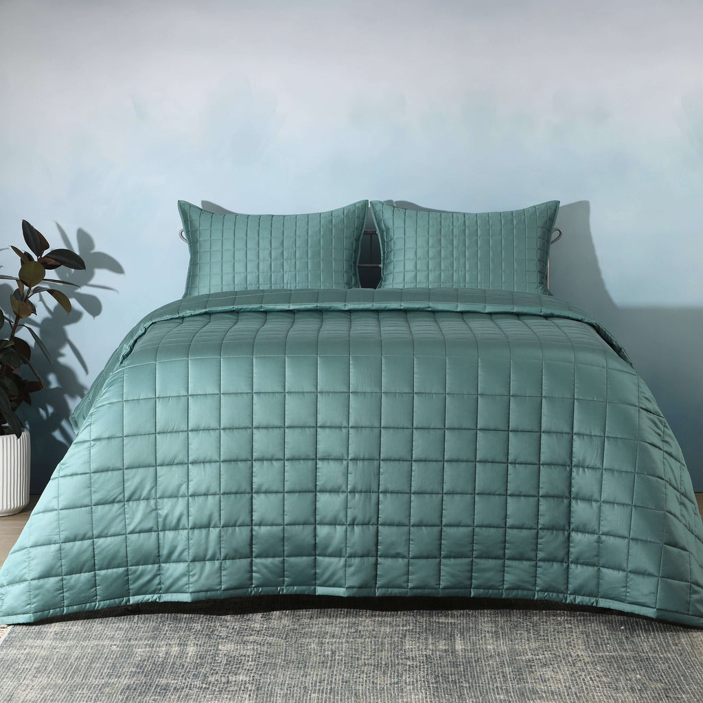 Full bed front on with teal quilted bedspread and plant: Teal bamboo cotton bedspread set quilted square pattern full bed Whites of London NZ