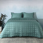 Full bed front on with teal quilted bedspread and plant: Teal bamboo cotton bedspread set quilted square pattern full bed Whites of London NZ