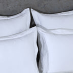 Close-up of four 750TC euro GOTS certified organic cotton pillowcases highlighting cord embroidery and flange detail