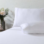 Close up of pillowcase and folded flat sheet with triple cord embroidery: 1250TC GOTS certified Organic Cotton Sheet Set white pillowcase flat sheet detail and Organic Cotton Fitted Sheet Whites of London 