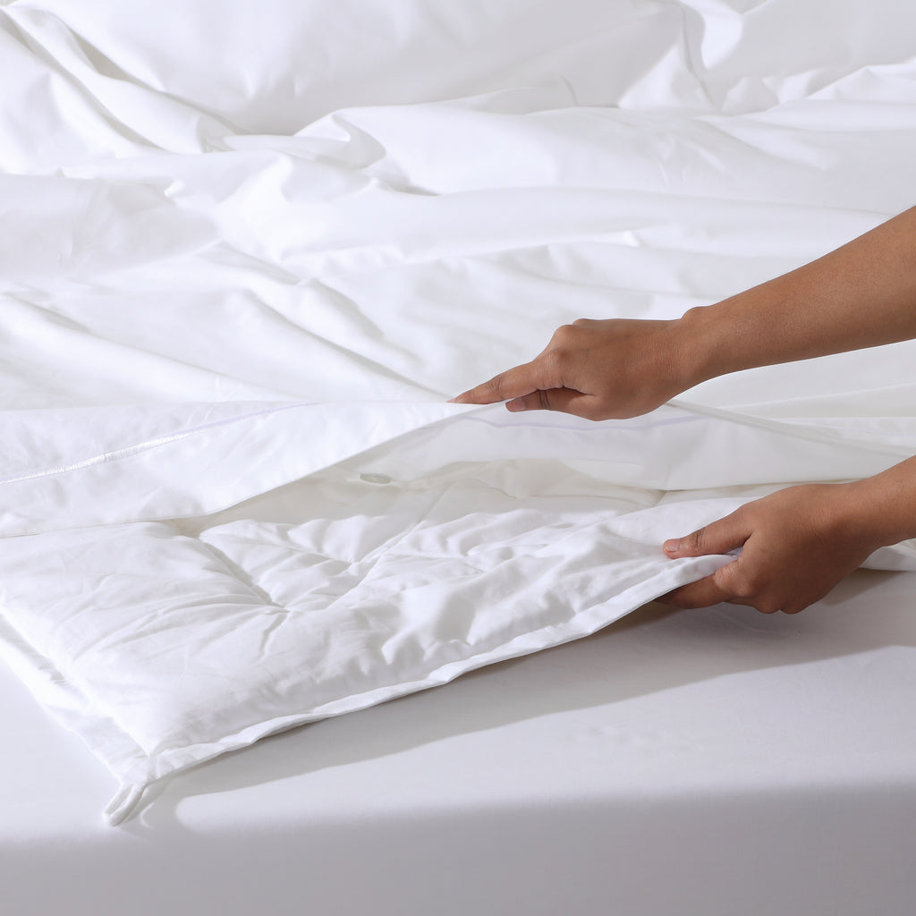 Whites of London Bamboo & Recycled Polyester Duvet Filler – being inserted into duvet cover New Zealand