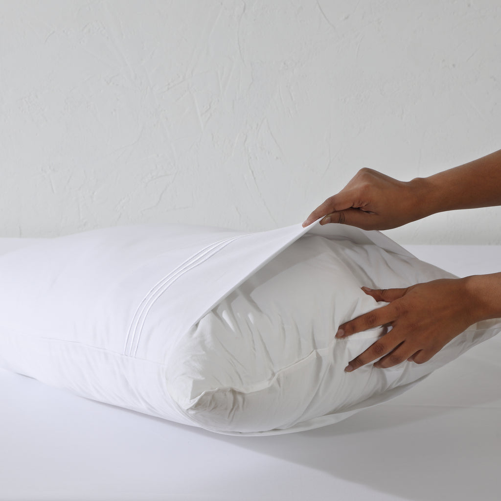 Whites of London Bamboo & Recycled Polyester Pillow Filler 50x75 being inserted into pillowcase Australia