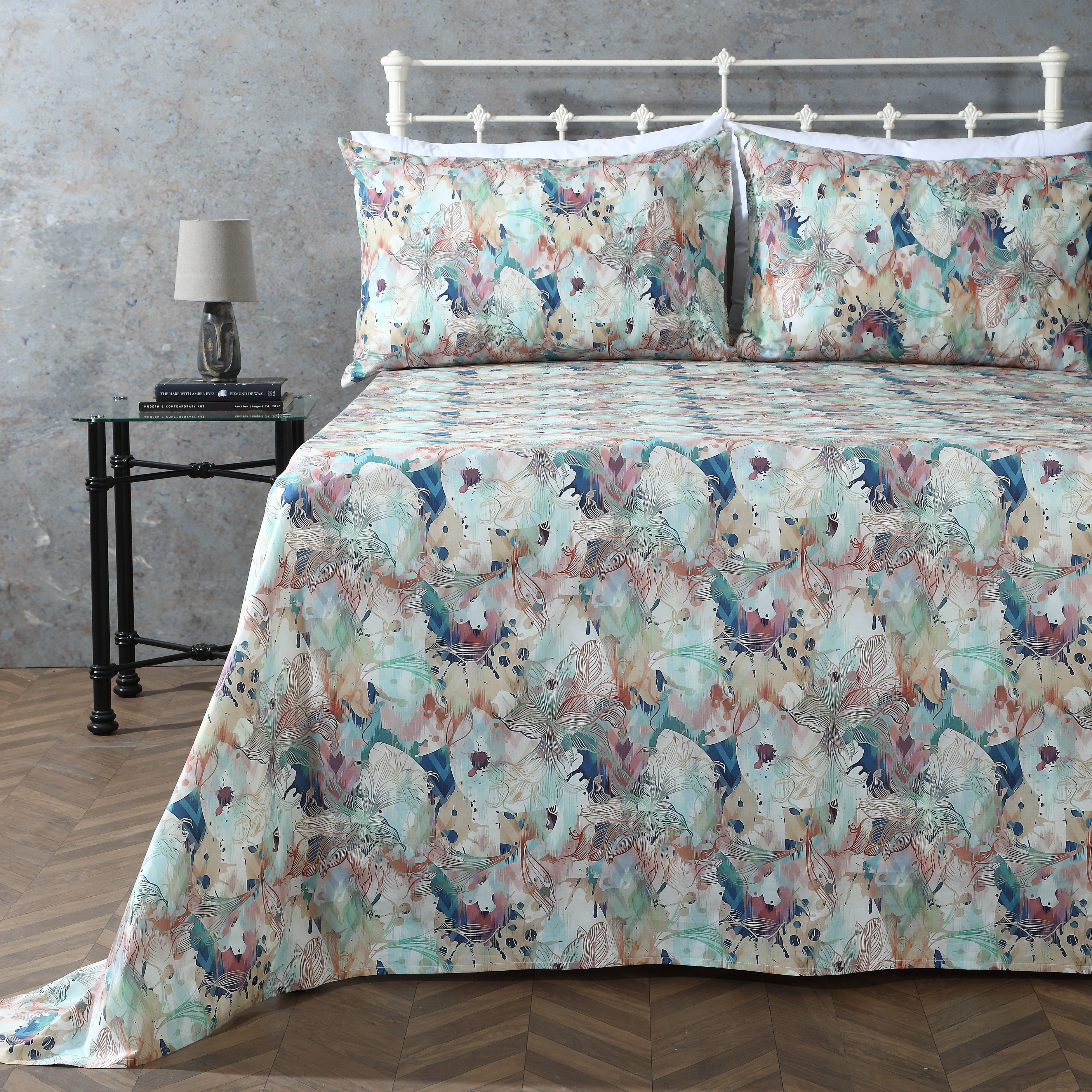 Organic cotton percale printed sheet set featuring a floral design with terracotta and teal accents.