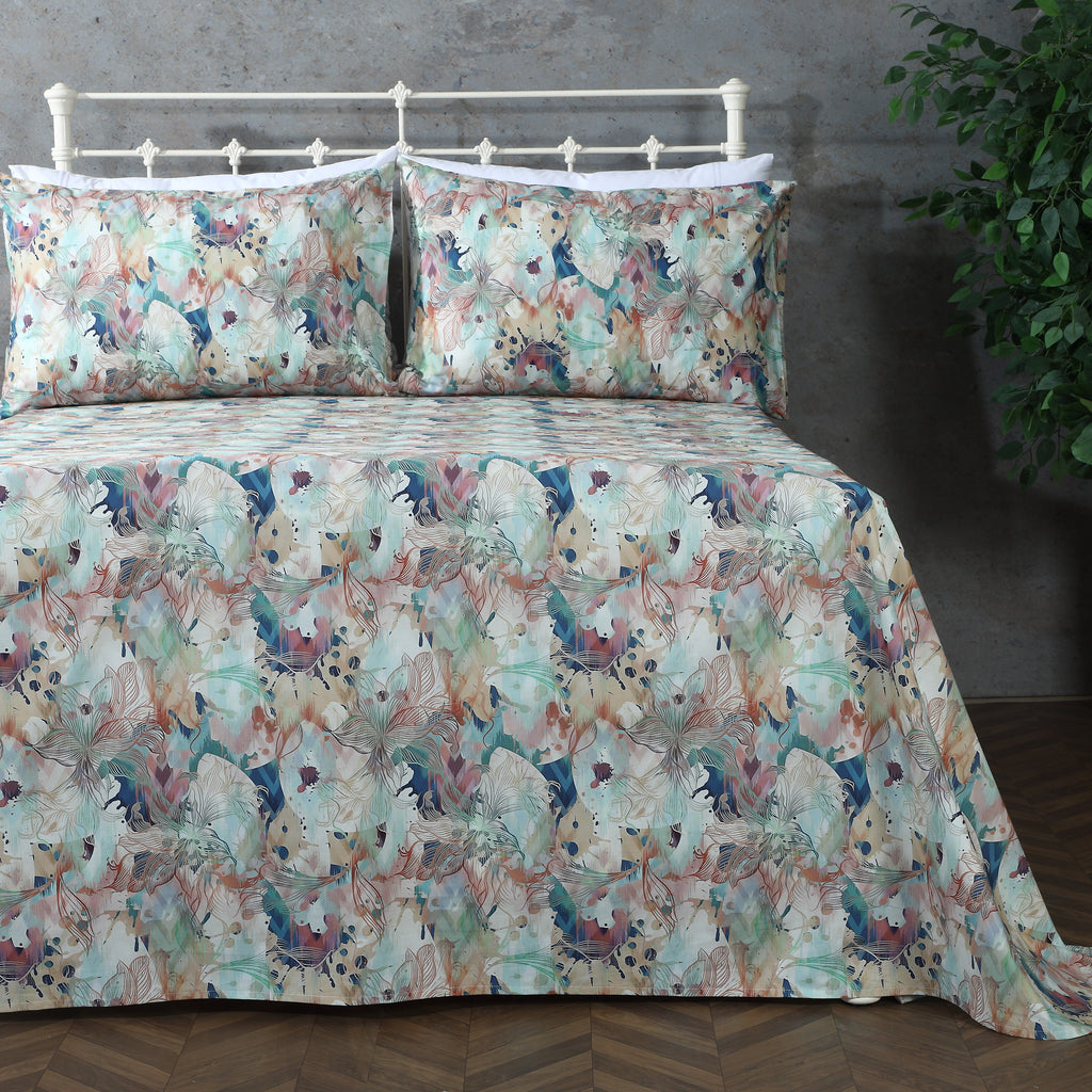 Organic cotton percale printed sheet set featuring a floral design in terracotta and teal tones.
