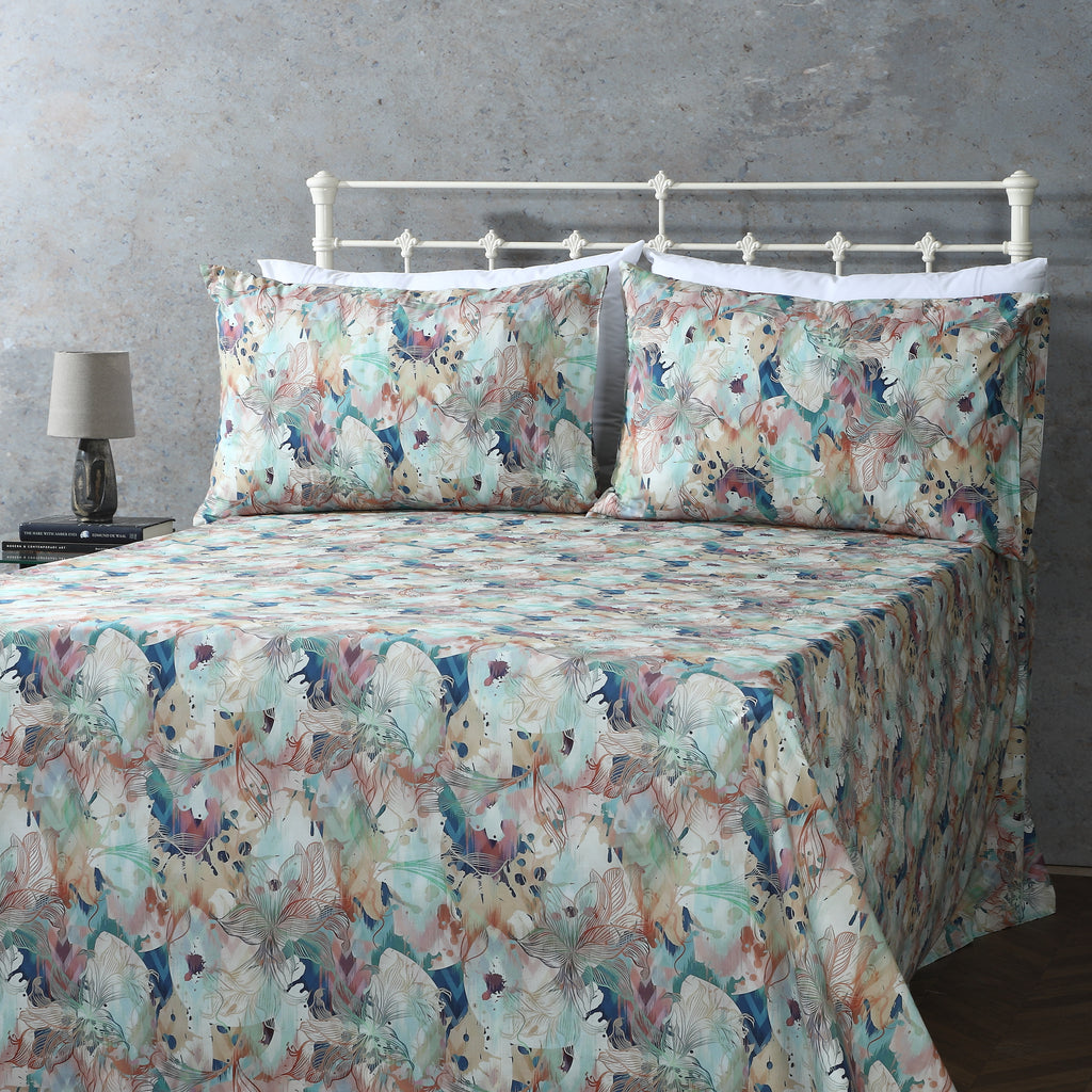 GOTS Certified Organic cotton percale printed sheet set featuring a floral pattern in terracotta and teal.